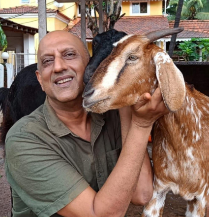 A man holding a goat