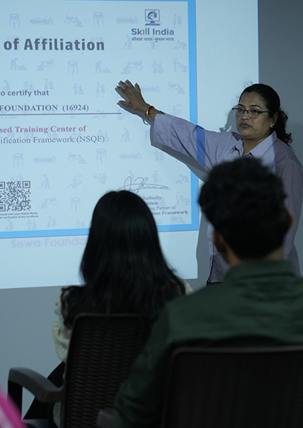 A teacher explaining concepts using modern technology at the Shrem Sewa Development Centre - Skill India.